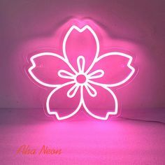 a pink neon sign with a flower on it