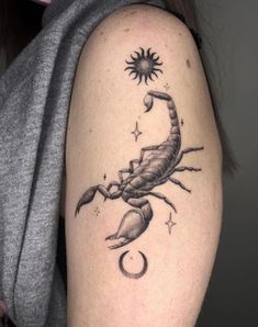 a woman's arm with a scorpion tattoo on it