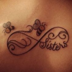 a woman's back with the word sisters written in cursive writing on it