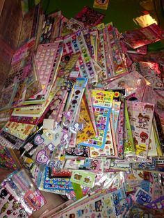 many different types of stickers are piled on top of each other in a pile