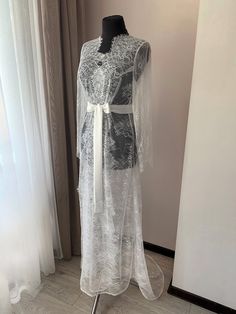 "Beautiful long lace bridal robe, the perfect touch to your special day! Make your wedding photos even more memorable by wearing this stunning lace robe while getting ready. Choose your size in the \"Frequently Asked Questions\". Shipping: All our items we send in gorgeous boxes. Every model we make for each of our customers individually. Items will be ready to be shipped within 5-7 business days after PayPal payment is complete. Shipping is made from Ukraine by standard-registered mail (include Wedding Day Robes, Long Bridal Robe, Lace Bridal Robe, Sheer Robe, Bridal Robe, Wedding Robe, Lace Bridal, Maxi Robes, Bridesmaid Robes