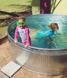 two children in a pool with goggles on