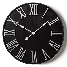 a black and white clock with roman numerals