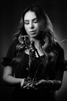 a woman holding a statue in her hands