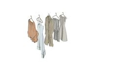 three dresses hanging on a clothes rack