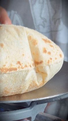 a flat bread sitting on top of a metal pan