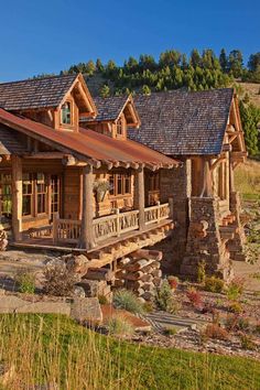 a rustic log cabin sits in the mountains