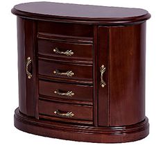 an oval wooden cabinet with drawers and brass pulls on the front door, in dark wood