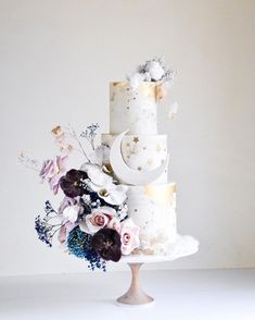 a three tiered cake with flowers on top