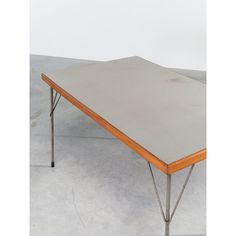 a table that is made out of concrete and has two legs on each side,