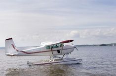 a small plane is floating in the water