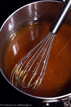 a metal bowl filled with sauce and whisk