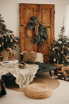 a living room decorated for christmas with wreaths on the door and other holiday decorations