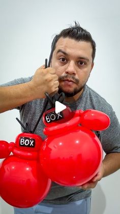 a man holding two red boxing gloves in front of his face