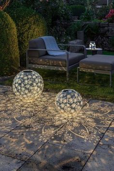 two blue and white balls sitting on top of a patio