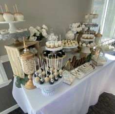 a table topped with lots of desserts and cupcakes