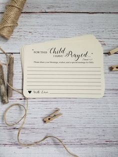 some crafting supplies are laying out on a white wooden table with twine and thread