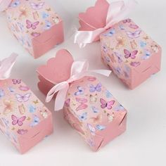 four pink boxes with hearts and butterflies on them