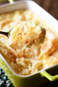 a spoon full of food in a green casserole dish