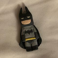 a batman toy sitting on top of a bed