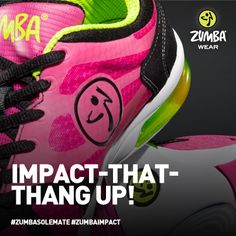 a pair of pink and green sneakers with the words impact that hang up on them