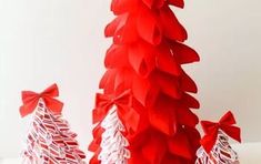 three red and white christmas trees with bows