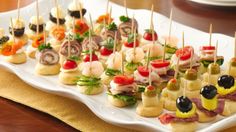 an assortment of appetizers are displayed on a platter with toothpicks