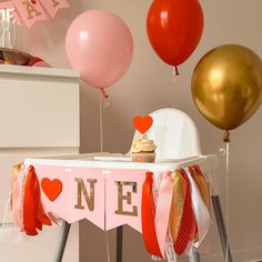 a baby's first birthday party with balloons and decorations