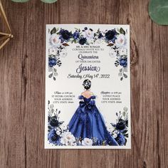 a wedding card with a blue dress and flowers on it