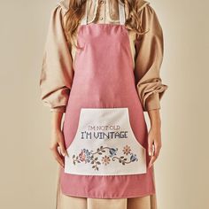 a woman wearing an apron that says i'm not old, i'm ultimate