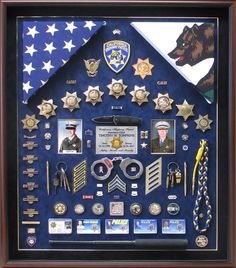 a shadow box is filled with badges and pins