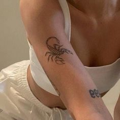 a woman with a scorpion tattoo on her arm