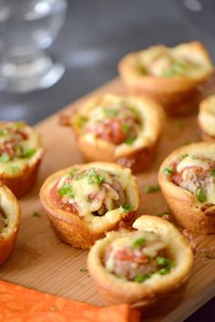 small appetizers are arranged on a wooden tray