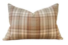 a tan plaid pillow on a white background