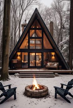 a - frame cabin in the woods with fire pit and adiron chairs around it