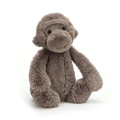 a stuffed monkey sitting on the ground