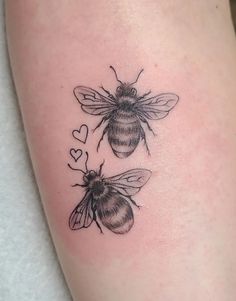 two bees with hearts on their legs