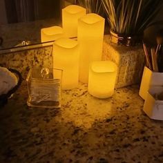 several lit candles sitting on top of a counter