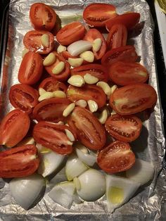 chopped tomatoes and onions on tin foil ready to be cooked