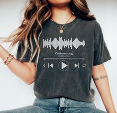 a woman wearing a t - shirt with an audio player on it's chest