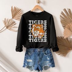 This makes the perfect vintage school spirit Tigers sweatshirt! This tigers sweatshirt is great for showing your school spirit! This distressed vintage tiger design is perfect on the popular Gildan brand sweatshirt. This vintage style sweatshirt will keep you warm throughout the school season!  A pre-shrunk, classic fit sweater that's made with air-jet spun yarn for a soft feel and reduced pilling. ** P R O D U C T **  - 50% cotton, 50% polyester  - Pre-shrunk  - Classic fit  - Direct to Garment print (no stencils or vinyl which means it will last a lot longer)   - Printed and Shipped in the USA  - Due to different monitor screens colors may vary ** S I Z I N G **  - Consult size chart in listings for measurements  - Sizing is Unisex for all tees, runs true to size  - For an oversized fit, Varsity Long Sleeve T-shirt For School, Collegiate Graphic Print Sweatshirt For College, Collegiate Graphic Print Sweatshirt For Campus, College Style Game Day Sweatshirt With Graphic Print, College Style Sweatshirt With Graphic Print For Game Day, College Style Sweatshirt With Graphic Print For Sports Season, College Style Graphic Sweatshirt For Game Day, Varsity Sweatshirt With Graphic Print For Campus, Varsity Graphic Print Sweatshirt For College