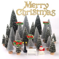 christmas trees with decorations and a snowman sitting in front of them on a white background