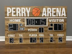 a wooden sign that says perry arena and shows the scoreboard for each team