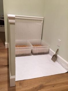 two plastic containers with food in them sitting on the floor next to a white wall