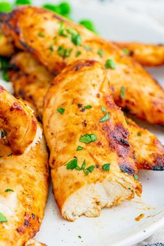 grilled chicken wings with garnishes on a white plate