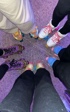 a group of people standing in a circle with their feet on the ground wearing colorful shoes