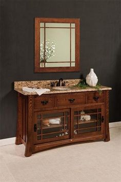 a bathroom vanity with two sinks and a mirror on the wall above it in a dark room