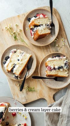 berries and cream layer cake on two plates with one slice cut out from the plate