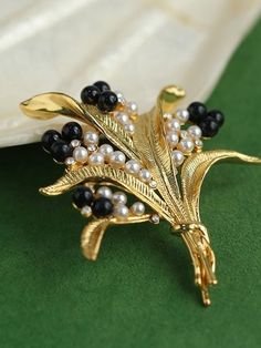 Indulge in vintage charm with our Vintage Pastoral Wheat Ear Black Onyx Pearl Brooch—a timeless accessory that exudes sophistication and nostalgia. Featuring an elegant wheat ear motif and lustrous black onyx and pearl accents, this brooch adds a touch of sophistication to any outfit. Metal: 18K Recycled Gold Plated On Brass Gemstone:Artificial pearl,Natural stone Size: 5*4.5cm Weight: about 12g Classic Black Brooches For Formal Occasions, Classic Black Brooches For Wedding, Classic Black Wedding Brooch, Classic Black Wedding Brooches, Classic Black Formal Brooches, Luxury Black Brooch Jewelry, Luxury Black Jewelry Brooch, Luxury Black Jewelry With Brooch, Antique Black Brooch For Evening