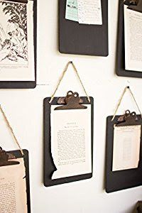 several pieces of paper hanging on a wall with clipboards attached to it and papers pinned to the wall